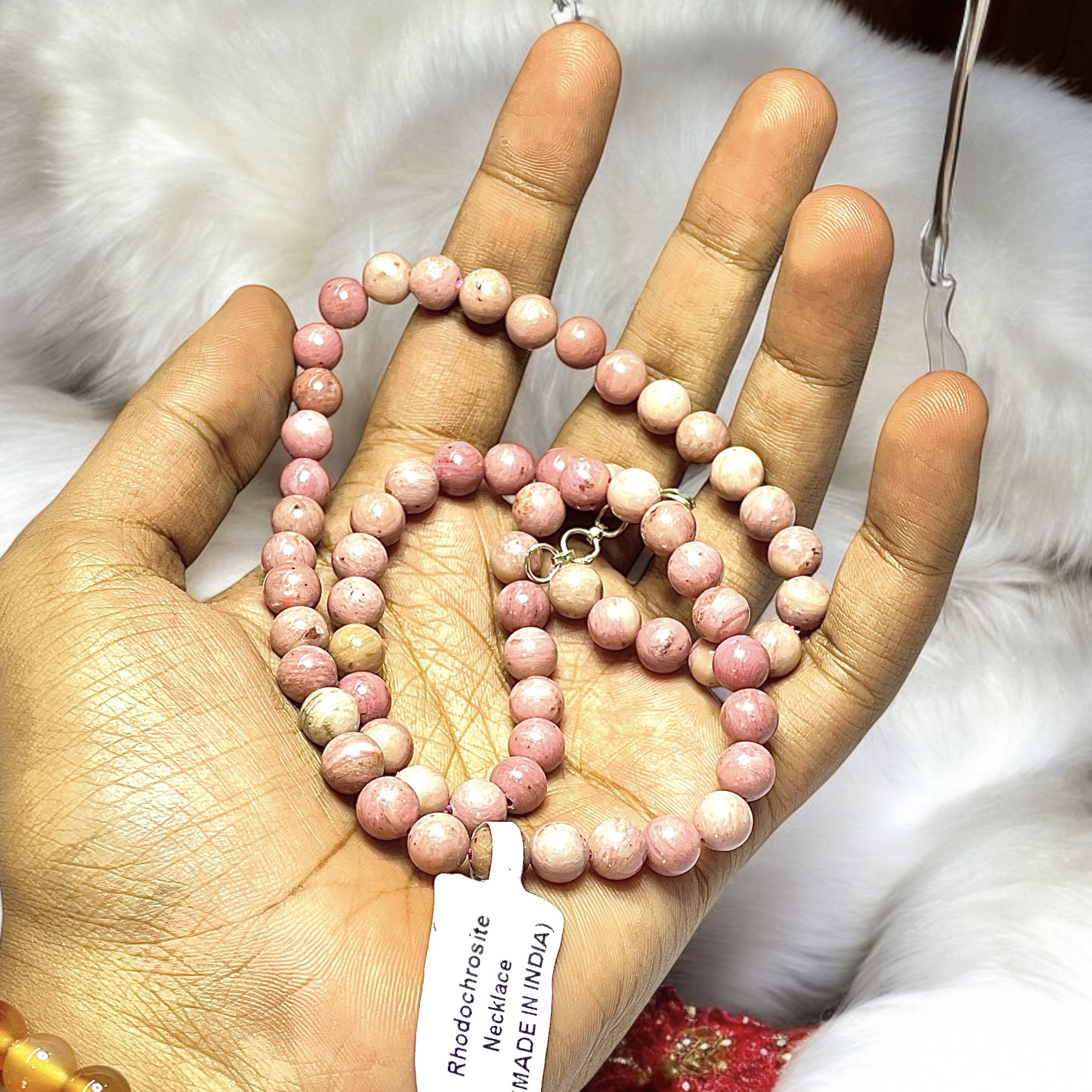 Rhodochrosite Crystal Necklace. Discover the Power of Natural Crystals with Rocksmins: Elegantly Crafted Crystal Necklaces Infused with Authentic Energies for Enhanced Well-Being and Spiritual Growth