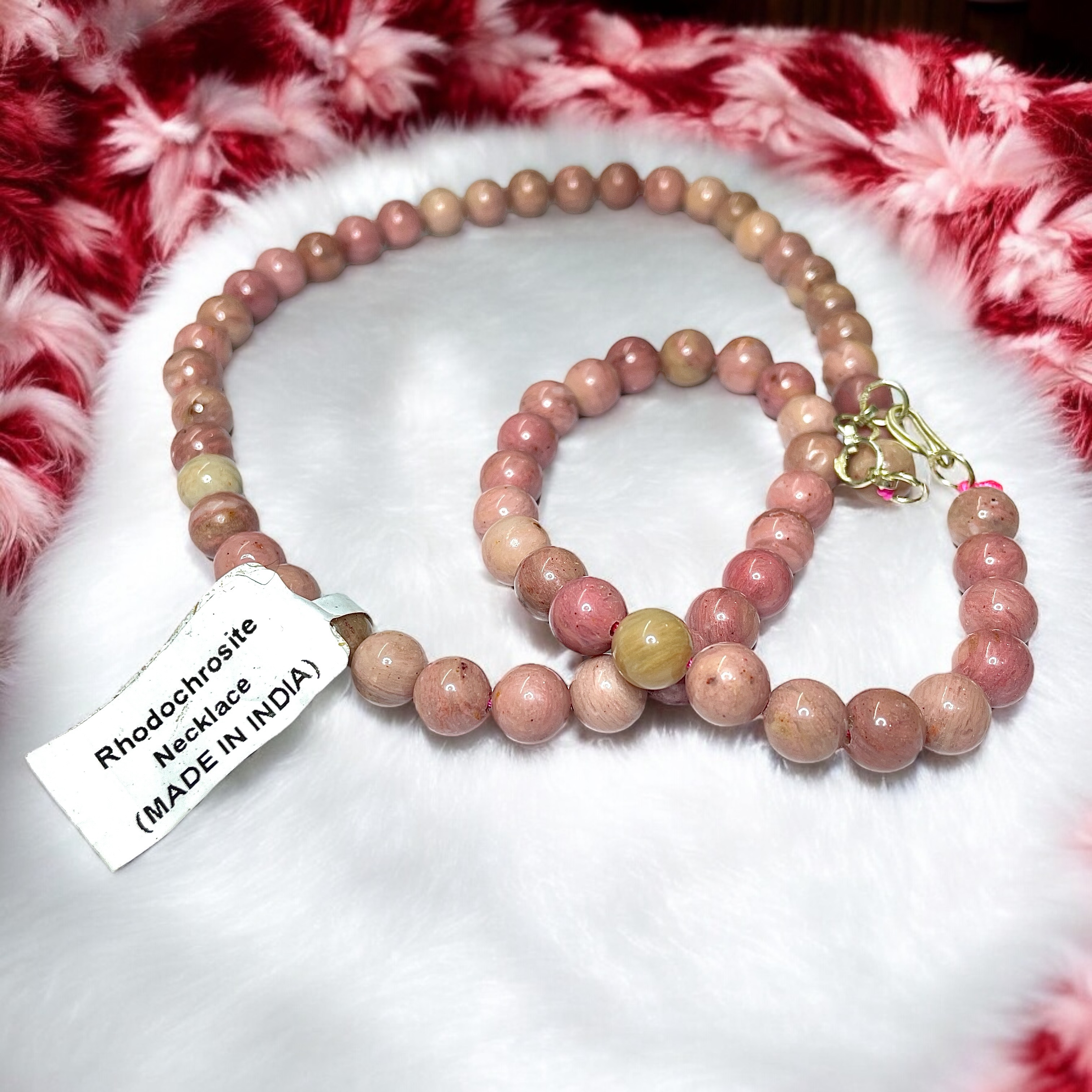 Rhodochrosite Crystal Necklace. Discover the Power of Natural Crystals with Rocksmins: Elegantly Crafted Crystal Necklaces Infused with Authentic Energies for Enhanced Well-Being and Spiritual Growth